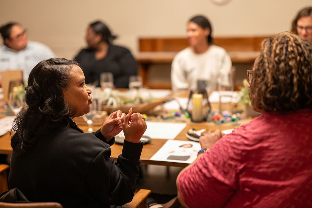 Leaders gathered around a table in conversation at a Generationalist Membership gathering